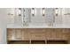 Bright bathroom boasts double sinks, wood cabinetry, and stylish modern lighting at 4329 Lambeth Dr, Raleigh, NC 27609