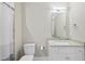 Modern bathroom featuring a clean design with a granite counter, ample storage, and a glass-enclosed shower at 4329 Lambeth Dr, Raleigh, NC 27609