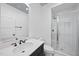 Modern bathroom featuring a sleek vanity, a glass enclosed shower, and a contemporary mirror with overhead lighting at 4329 Lambeth Dr, Raleigh, NC 27609