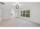 Airy bedroom with ample natural light and a neutral color palette, modern light fixture and carpeted floor at 4329 Lambeth Dr, Raleigh, NC 27609