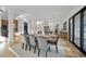 Dining room with seating for six, modern light fixture, and hardwood floors at 4329 Lambeth Dr, Raleigh, NC 27609