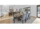 Dining room adjacent to kitchen featuring a modern light fixture and seating for six at 4329 Lambeth Dr, Raleigh, NC 27609