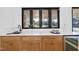 Elegant kitchen showcasing wood cabinetry, stone countertops, and a view to the backyard at 4329 Lambeth Dr, Raleigh, NC 27609