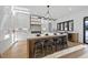 Island with seating, modern light fixture, and white cabinets at 4329 Lambeth Dr, Raleigh, NC 27609
