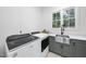 Modern laundry room with stainless steel sink, green cabinets, and new appliances at 4329 Lambeth Dr, Raleigh, NC 27609
