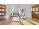 Cozy living room featuring hardwood floors, white walls, a modern light fixture, and neutral furniture at 4329 Lambeth Dr, Raleigh, NC 27609
