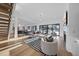 Open concept living room with fireplace, hardwood floors, and sliding glass doors to the backyard at 4329 Lambeth Dr, Raleigh, NC 27609