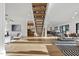 Bright living room featuring hardwood floors, stylish furniture, and a modern floating staircase at 4329 Lambeth Dr, Raleigh, NC 27609