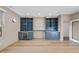 Custom wet bar includes custom cabinets, refrigerator, open shelving, and marble countertop at 4329 Lambeth Dr, Raleigh, NC 27609