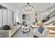 Bright living room featuring hardwood floors, white walls, a modern light fixture, and neutral furniture at 4329 Lambeth Dr, Raleigh, NC 27609