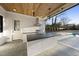 Outdoor kitchen with white brick, dark countertops, and a stainless steel grill at 4329 Lambeth Dr, Raleigh, NC 27609