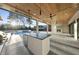 Covered outdoor living area featuring an outdoor kitchen, fireplace, ceiling fans, and views of the pool at 4329 Lambeth Dr, Raleigh, NC 27609