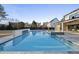Beautiful backyard pool with stone accents, connected spa, and outdoor entertaining space at 4329 Lambeth Dr, Raleigh, NC 27609