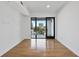 A sunny bedroom with hardwood floors, a balcony, and neutral decor at 523 S West St # 502, Raleigh, NC 27601