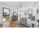 Bright bedroom featuring large windows, hardwood floors, and a stylish decor at 523 S West St # 502, Raleigh, NC 27601