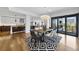 Open-concept dining room with a designer light fixture, balcony access, and views of the kitchen at 523 S West St # 502, Raleigh, NC 27601