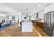 Open kitchen with long island and stainless steel appliances, connecting to dining area at 523 S West St # 502, Raleigh, NC 27601