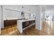 Modern kitchen with sleek white cabinets, stainless steel appliances, and an expansive island with seating at 523 S West St # 502, Raleigh, NC 27601