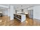 Open kitchen with long island, stainless steel appliances and hardwood floors at 523 S West St # 502, Raleigh, NC 27601