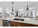 Modern kitchen with stainless steel sink, white countertops, wood cabinets and pendant lighting at 523 S West St # 502, Raleigh, NC 27601