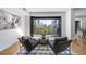 Bright living room featuring two leather chairs, an area rug, and balcony access with city views at 523 S West St # 502, Raleigh, NC 27601