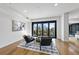 Modern living room featuring hardwood floors, an area rug, and balcony access with city views at 523 S West St # 502, Raleigh, NC 27601