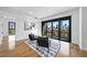 Stylish living room with modern chairs, area rug, and a sliding glass door to a balcony with city views at 523 S West St # 502, Raleigh, NC 27601