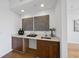 Modern wet bar with wood cabinetry, quartz countertop, and designer accents at 523 S West St # 502, Raleigh, NC 27601