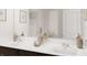 Modern bathroom with double sinks, white countertops, and decorative accents at 683 Mirkwood, Apex, NC 27523