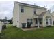 View of a clean, open backyard featuring lush green grass, a patio, and a back exterior view of the home at 711 Weathervane Way, Rocky Mount, NC 27803