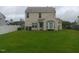 Spacious backyard featuring lush green grass, a patio area, and a privacy fence at 711 Weathervane Way, Rocky Mount, NC 27803