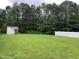 Spacious backyard with a storage shed and fenced perimeter, offering privacy and practicality at 711 Weathervane Way, Rocky Mount, NC 27803