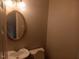 Simple powder room with a pedestal sink, oval mirror, and neutral paint at 711 Weathervane Way, Rocky Mount, NC 27803