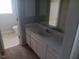 Bathroom featuring a single sink vanity, large mirror, and view of the toilet at 711 Weathervane Way, Rocky Mount, NC 27803