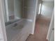 Bathroom with a single sink vanity, large mirror and neutral color palette at 711 Weathervane Way, Rocky Mount, NC 27803