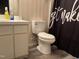 Bathroom featuring a toilet, vinyl floors, white vanity, and a unique shower curtain at 711 Weathervane Way, Rocky Mount, NC 27803