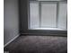 Bedroom featuring neutral walls, plush carpeting, and a bay window at 711 Weathervane Way, Rocky Mount, NC 27803