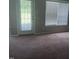 Bedroom featuring large window and access to the backyard at 711 Weathervane Way, Rocky Mount, NC 27803