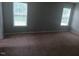 Large bedroom with carpeted flooring, natural light, and neutral wall color at 711 Weathervane Way, Rocky Mount, NC 27803