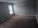Neutral bedroom features carpeting and natural light through the window at 711 Weathervane Way, Rocky Mount, NC 27803