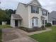 Side view of a well-maintained two-story home with neutral siding, clean driveway, and landscaped flowerbed at 711 Weathervane Way, Rocky Mount, NC 27803