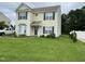 Inviting two-story home featuring a green lawn, charming curb appeal, and attractive shutters at 711 Weathervane Way, Rocky Mount, NC 27803