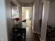 Hallway with hardwood floors transitioning into a carpeted living space with view to the front door at 711 Weathervane Way, Rocky Mount, NC 27803