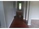 Long hallway with hardwood flooring provides access to other rooms in the home at 711 Weathervane Way, Rocky Mount, NC 27803