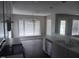 Open-concept kitchen with wood floors, stainless steel appliances, and a bright dining space at 711 Weathervane Way, Rocky Mount, NC 27803