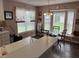 Cozy eat-in kitchen featuring bright windows, stylish lighting, and a dining area at 711 Weathervane Way, Rocky Mount, NC 27803