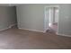 Open-concept living room featuring neutral walls and carpeted floor at 711 Weathervane Way, Rocky Mount, NC 27803
