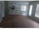 Open living space with sliding glass doors, windows, and a kitchen with a breakfast bar at 711 Weathervane Way, Rocky Mount, NC 27803
