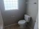 Bathroom featuring a standard toilet, a small window, and neutral wall color at 711 Weathervane Way, Rocky Mount, NC 27803