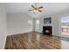 Bright living room with wood floors, a fireplace, and lots of natural light from the windows at 75 Pebblestone Ct, Willow Springs, NC 27592